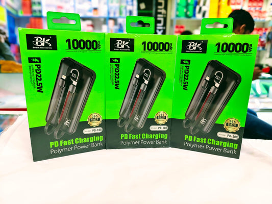 Three packages of BK 10000 PD Fast Charging Polymer Power Bank on a white surface with a blurred store background.